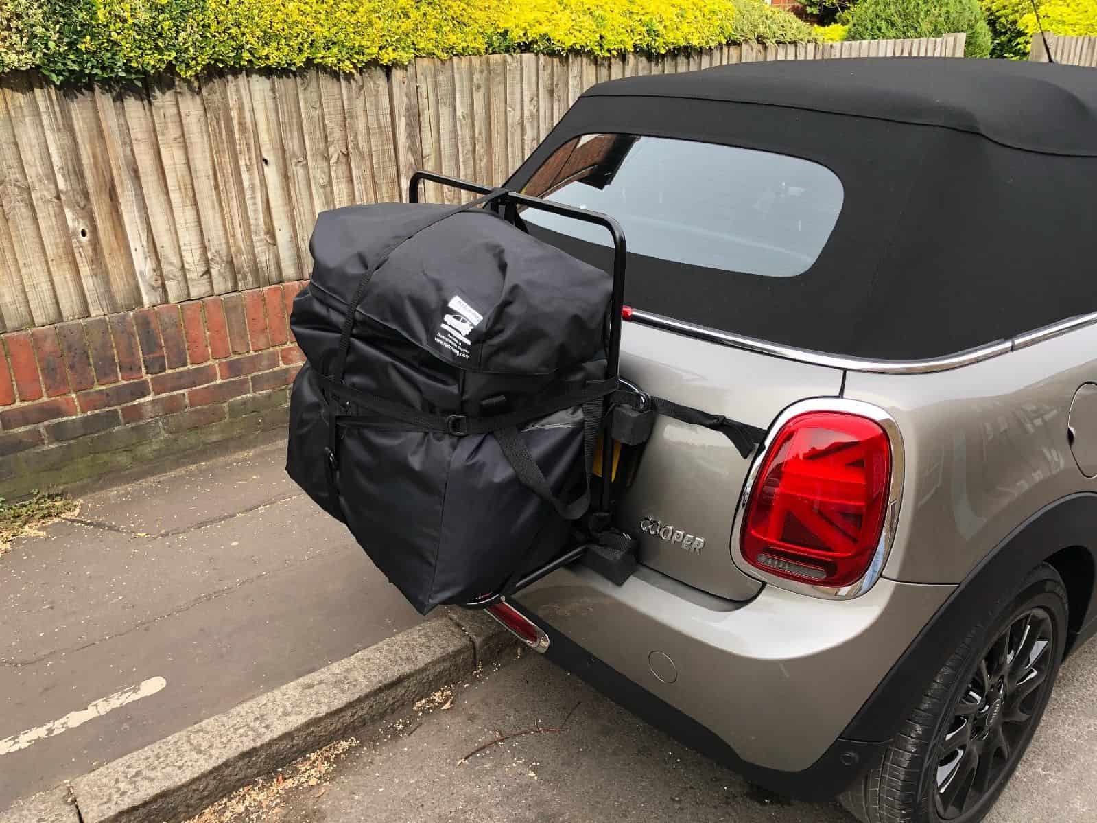 silver graphite mini convertible with a hatch-bag luggage rack fitted to the trunk