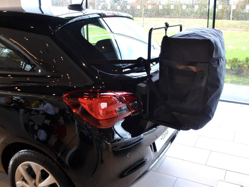 side view of a hatch-bag roof box alternative on a black vauxhall corsa