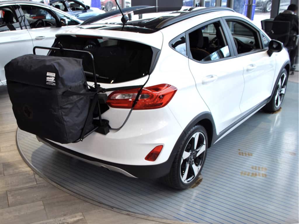 white ford fiesta with a hatch-bag roof box alternative fitted to the rear