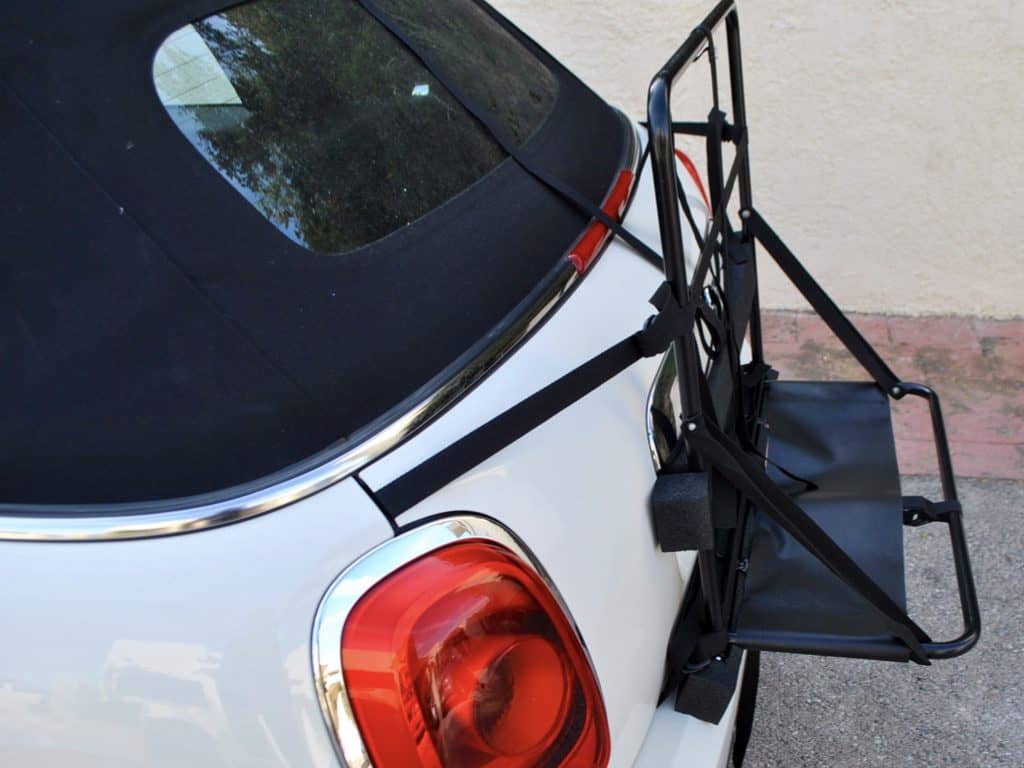hatchbag luggage frame attached to a white mini cooper s convertible