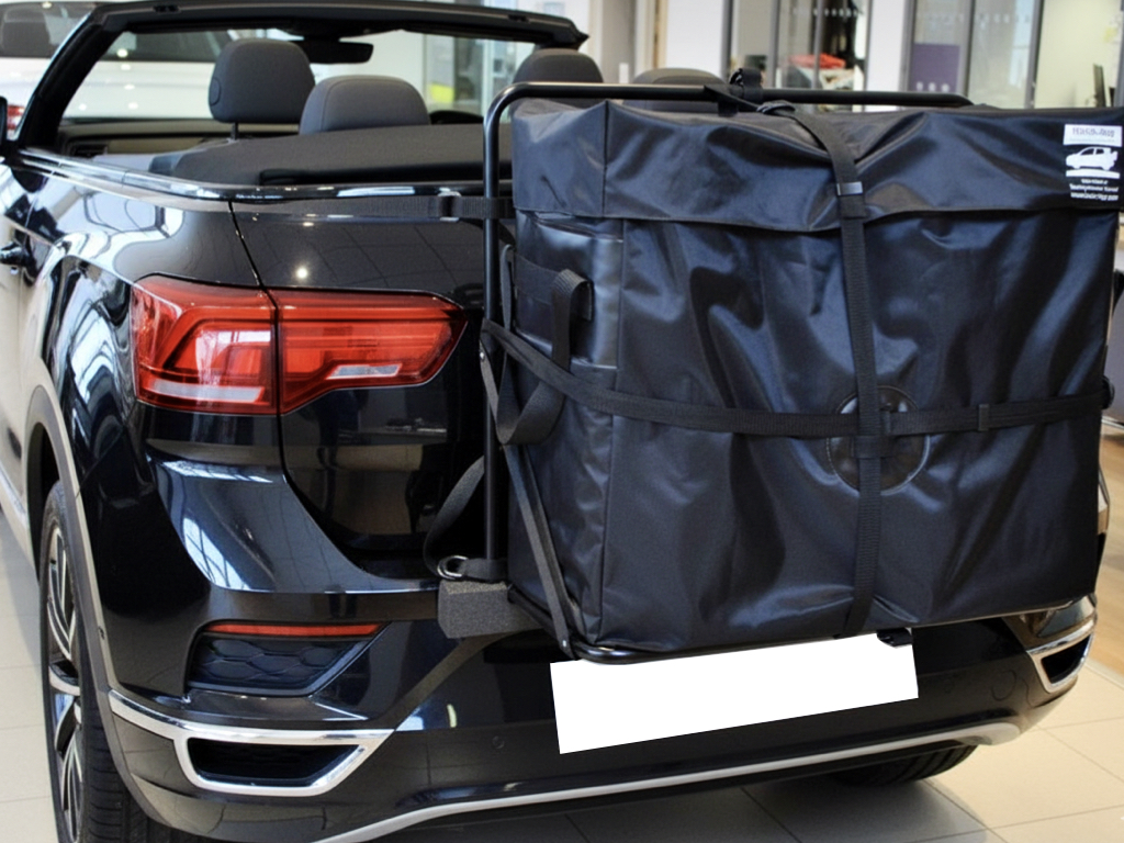 Black Volkswagen VW T-Roc Convertible with a hatch-bag luggage carrier rack fitted to then rear, photographed in a VW showroom