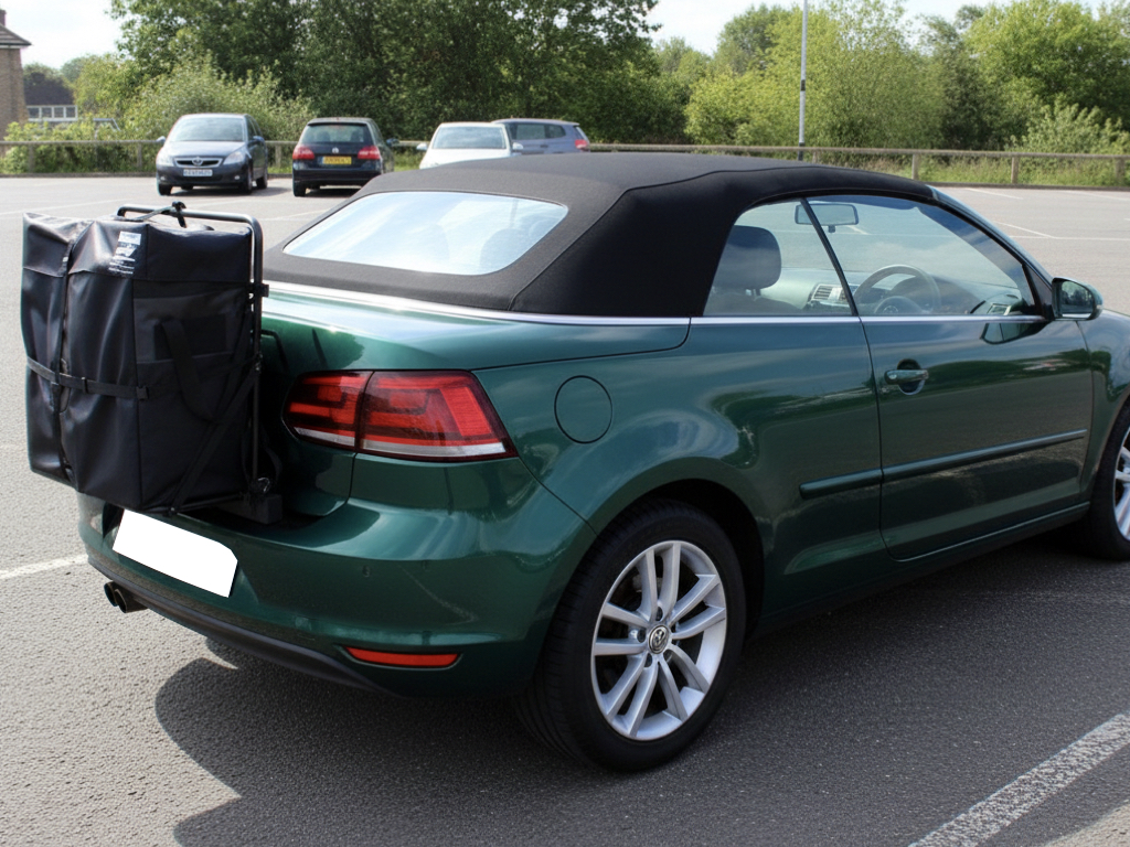 Green VW Golf mk4 convertible with a hatchbag luggage rack fitted to the rear parked in a car park photographed from the rear 