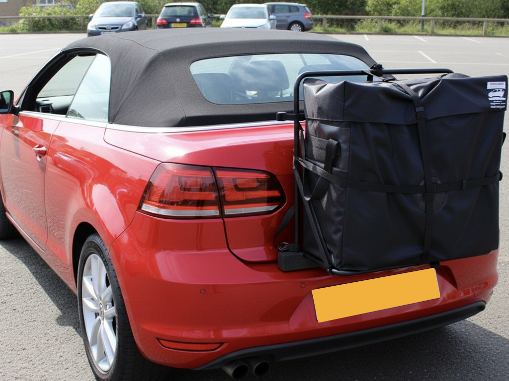Red VW Golf mk4 convertible with a hatchbag luggage rack fitted to the rear parked in a car park photographed from the rear